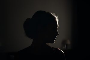 Woman standing looking off into the distance.