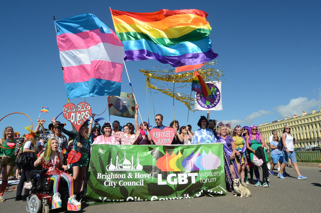 People waving flags and gathering together at the Brighton Pride 2016