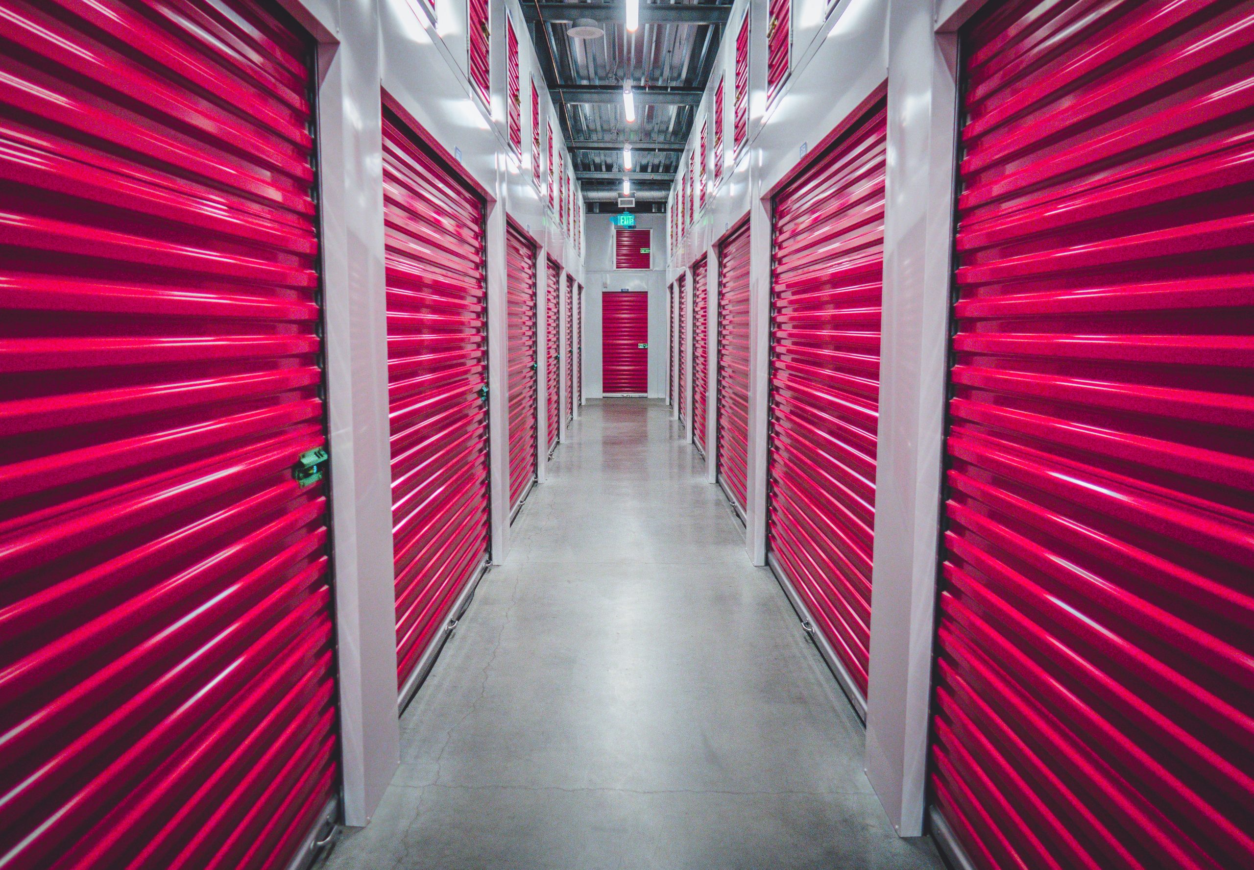 A series of red storage lockers line a corrider