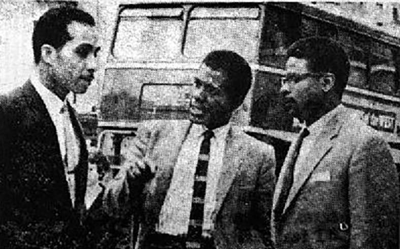 Audley Evans, Paul Stephenson and Owen Henry discussing the boycott in front of a bus