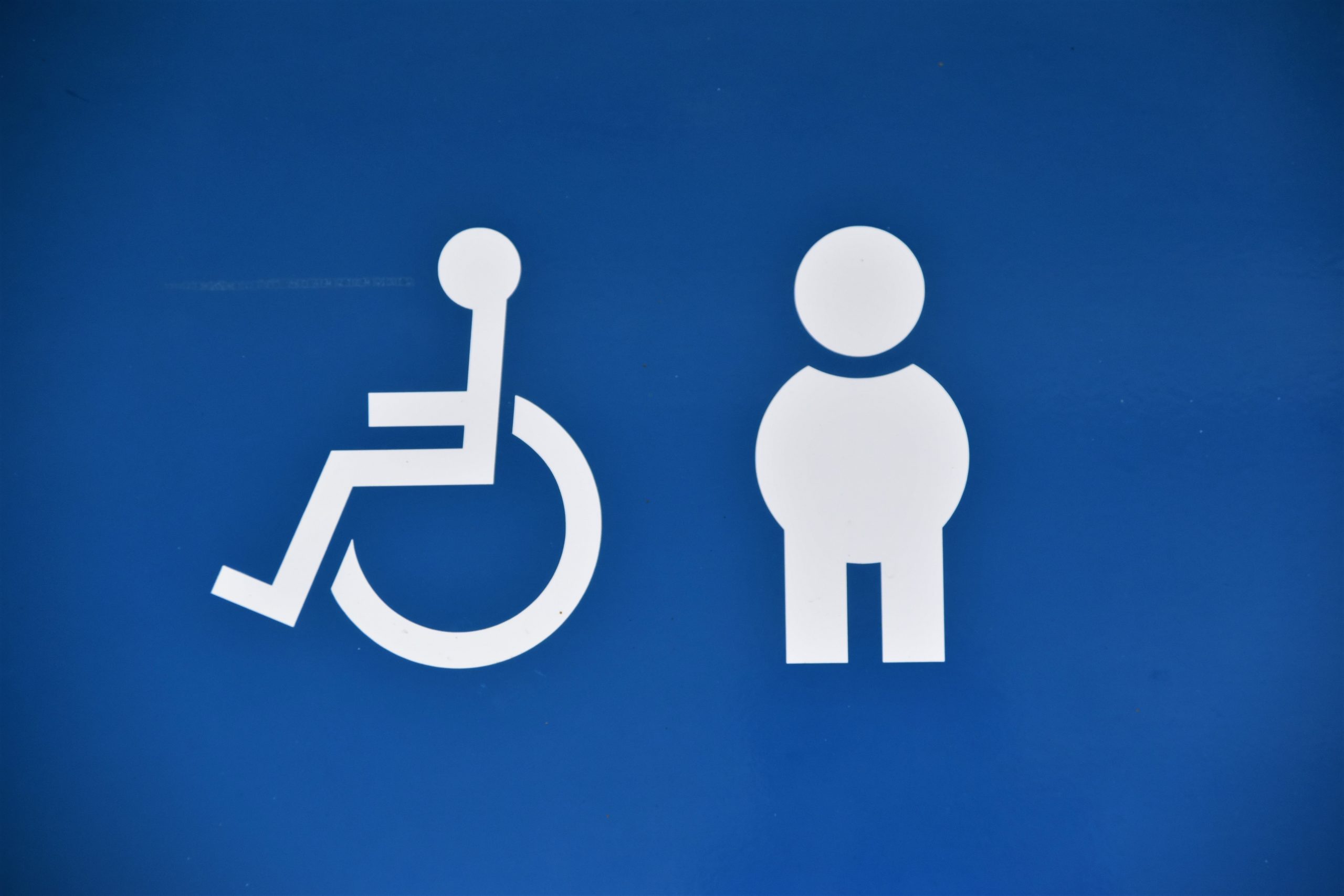 A blue background shows a white disabled symbol and a stick figure standing to represent hidden disabilities.