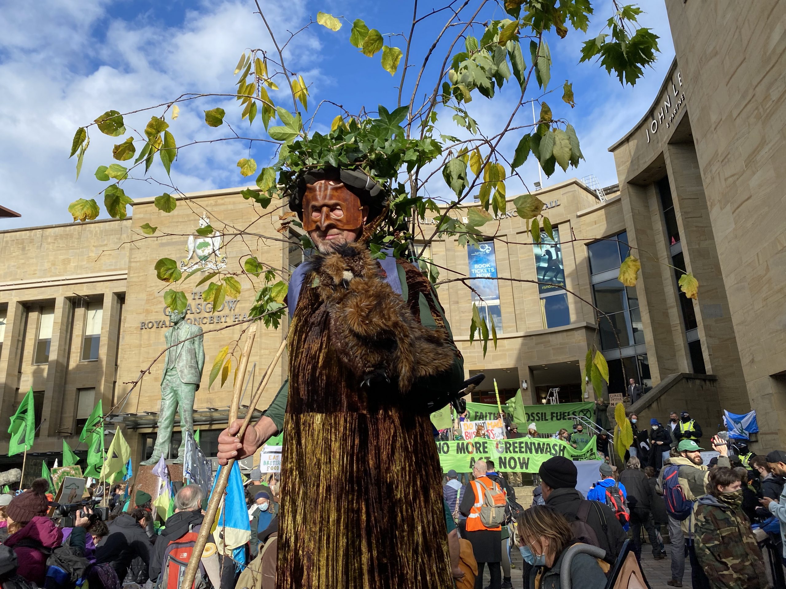 A man calling himself 'Stumpy' walks on stilts through the streets of Glasgow at the Extinction Rebellion demo dressed in a full tree costume.