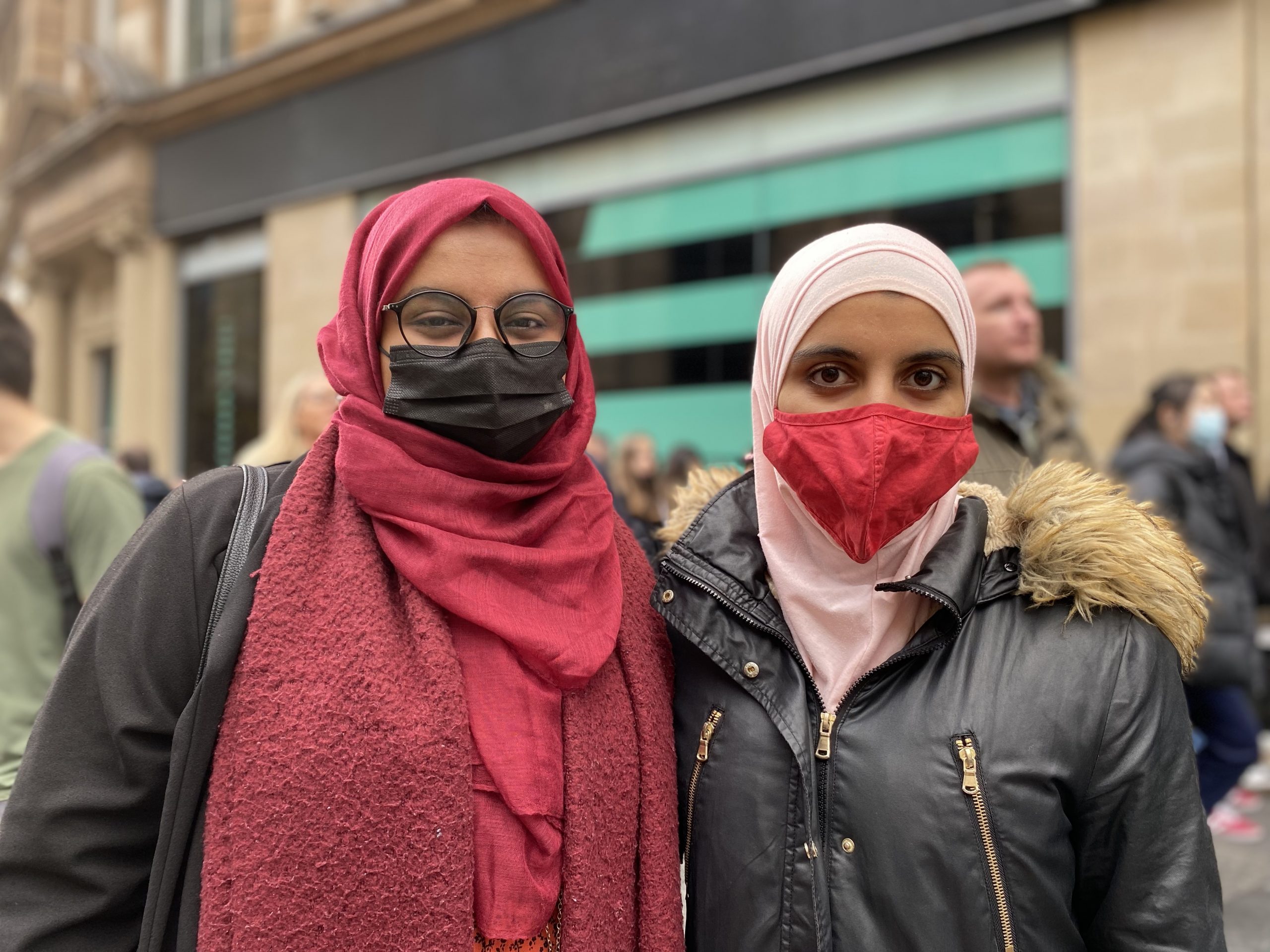 Sisters Yasmin and Tasnim walk through the streets of Glasgow together at the Extinction Rebellion demo wearing jackets, headscarves and facemasks