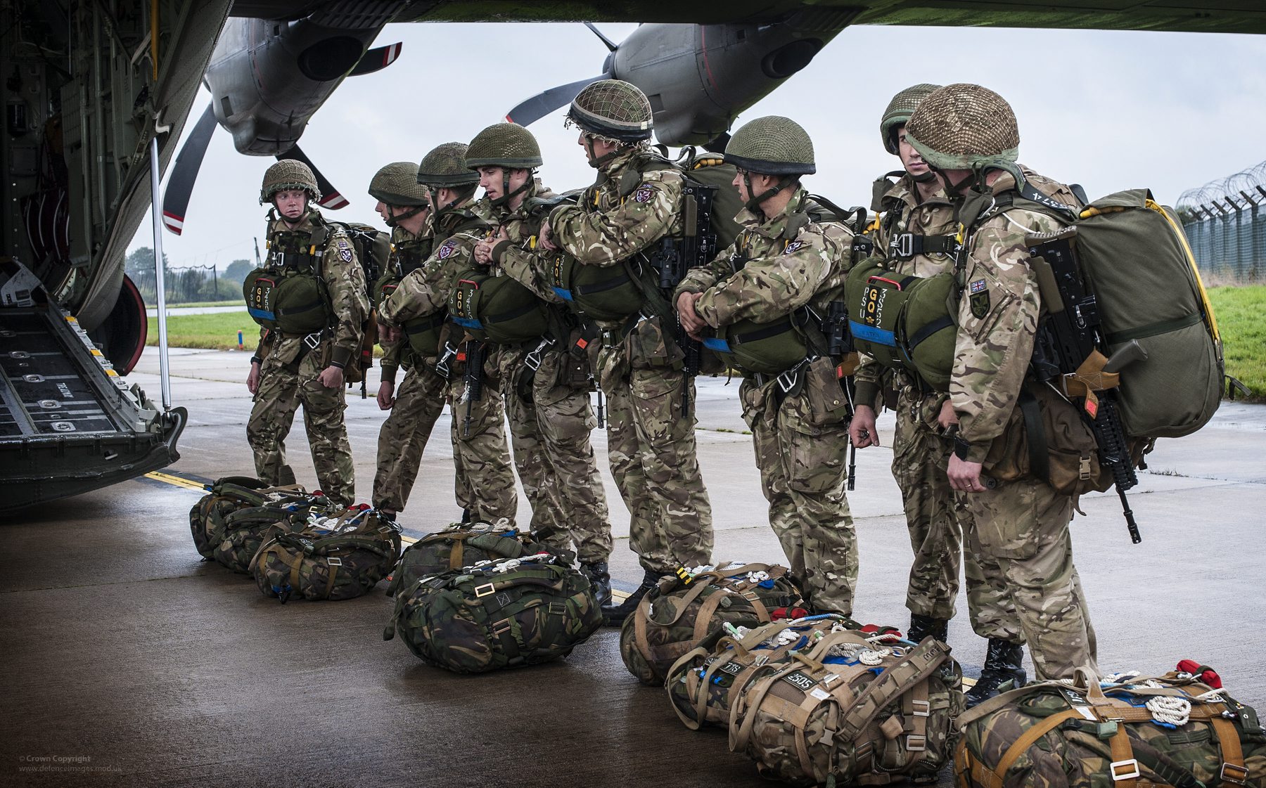 Soldiers of B Company of 2nd Battalion The Parachute Regiment line up to board a Royal Air Force Hercules at RAF Leeming, North Yorkshire. 