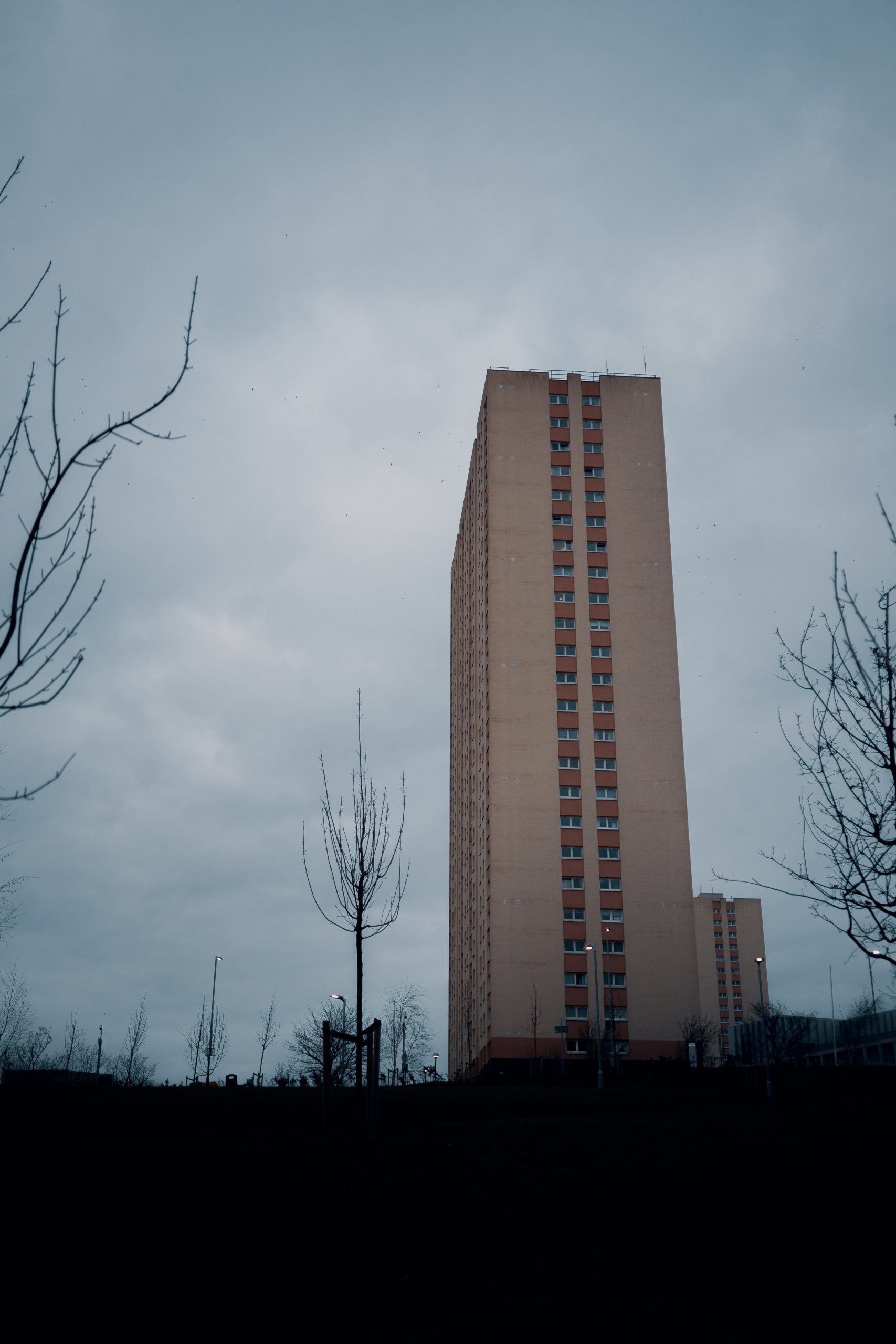 A wide shot of a high rise flat building in England