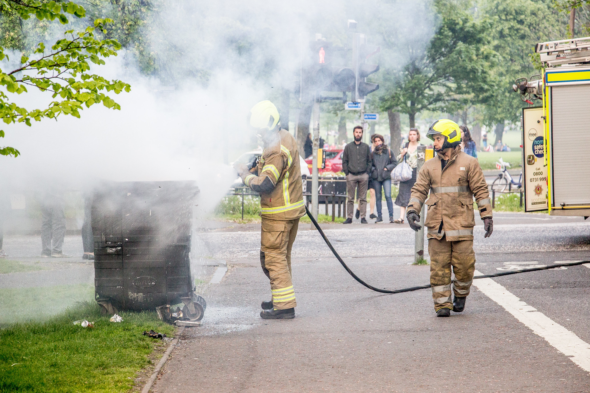 Two firefighters extinguish a small blaze on the streets of Edinburgh