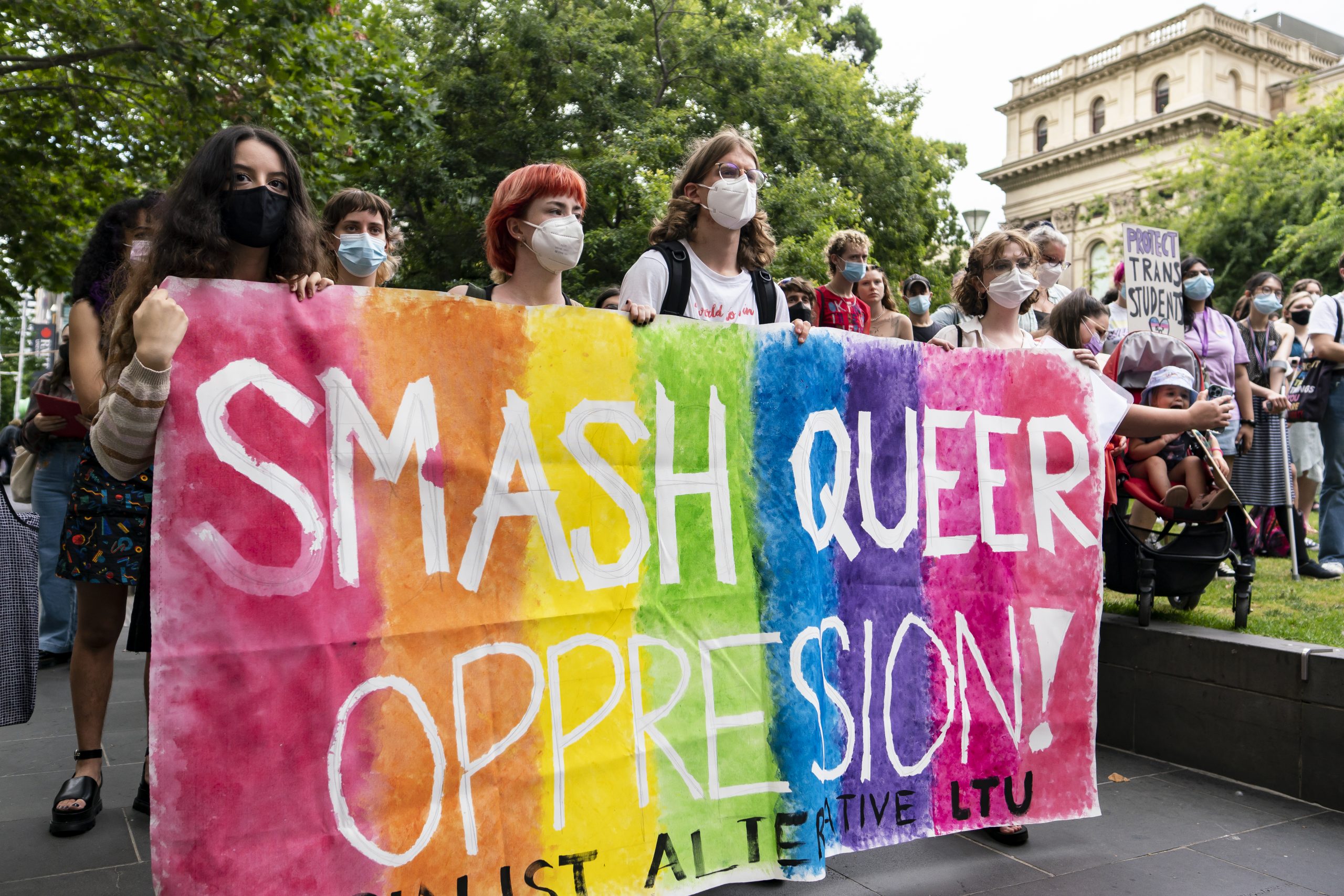 A banner reads:"Smash Queer Oppression"