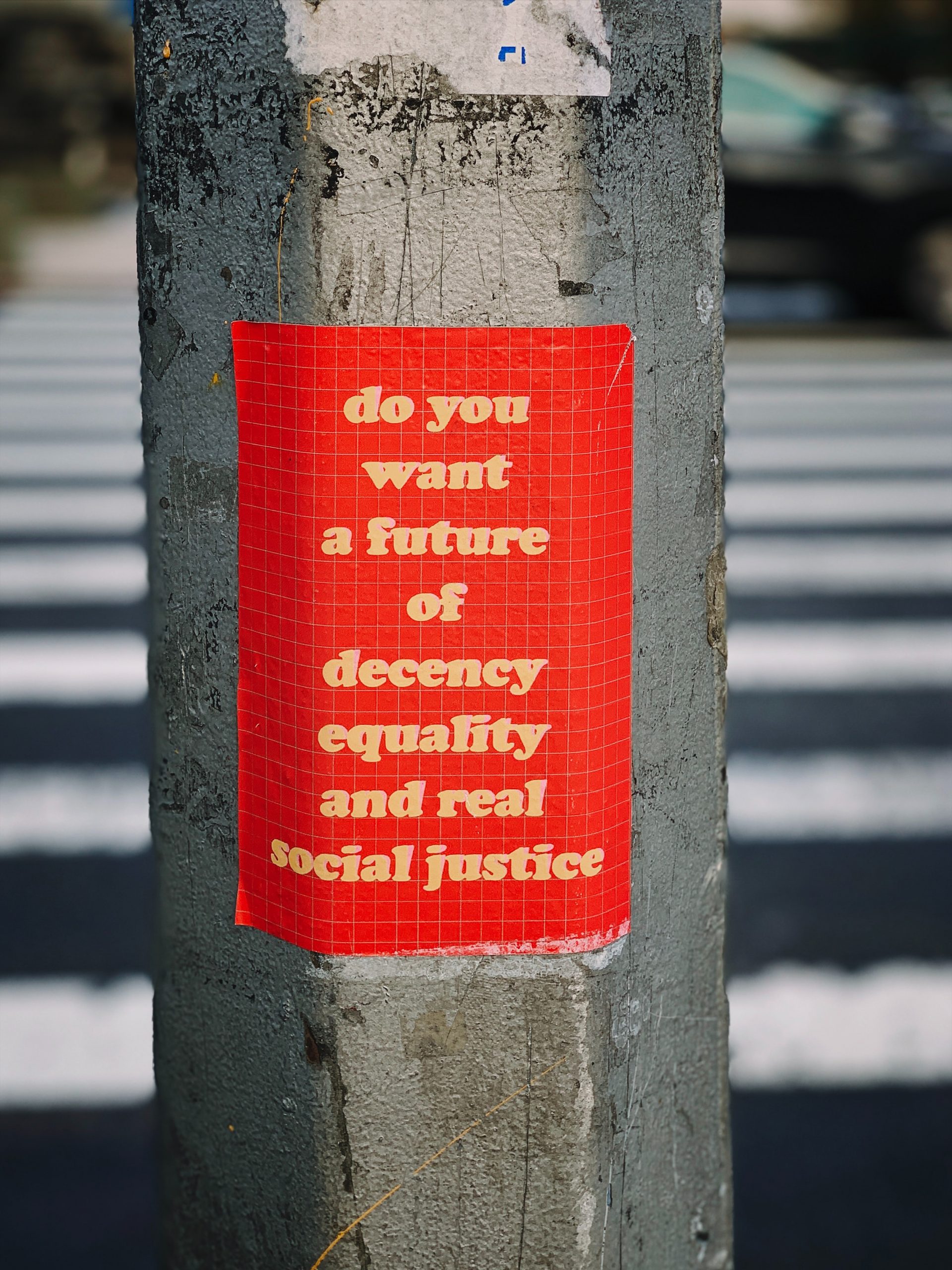 A red sticker with yellow lettering reads: "do you want a future of decency equality and