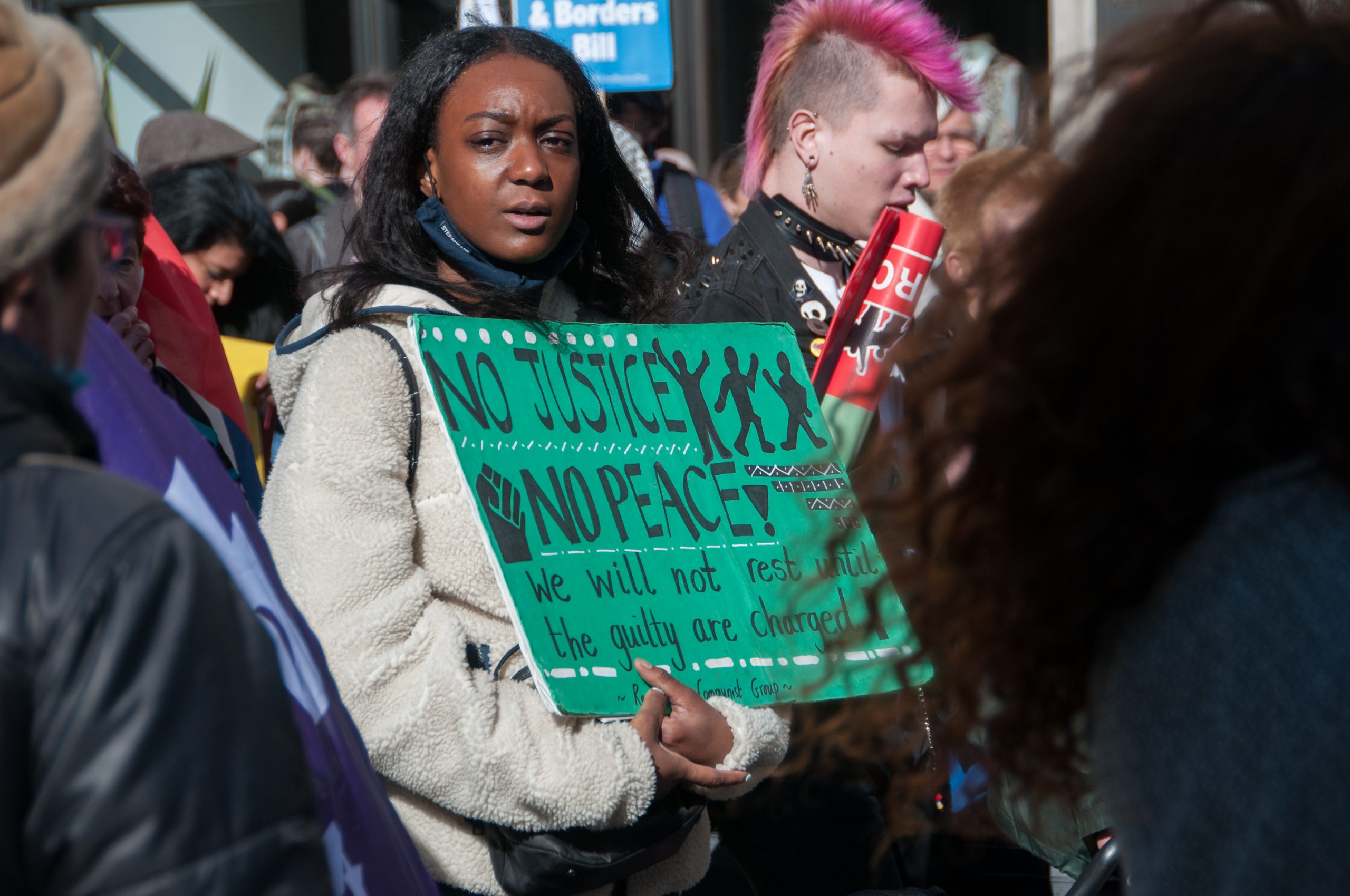 A girl holds a sign at a protest