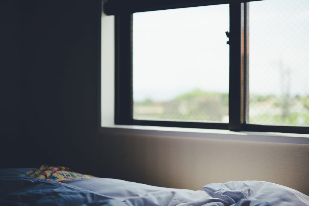 A bed in front of a window