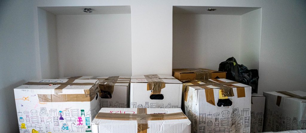 Cardboard boxes of possessions in an empty room